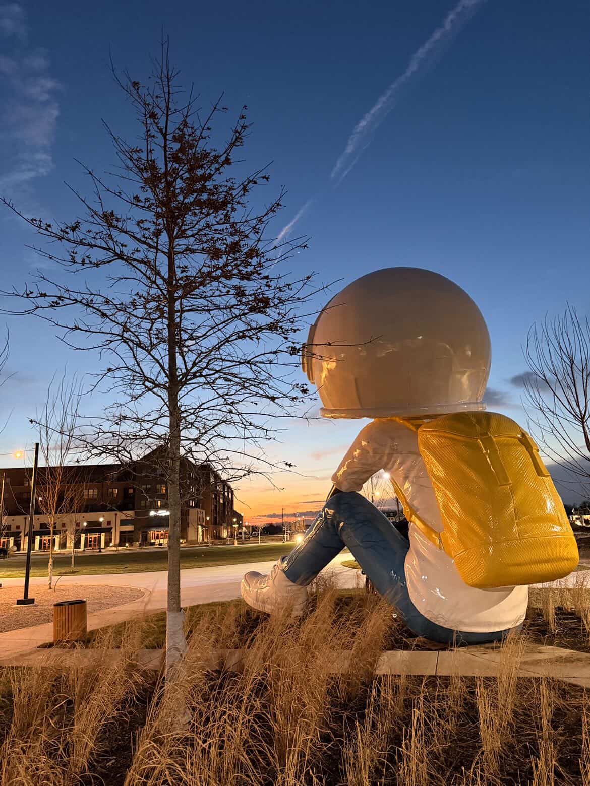 25-foot Aku Dreamgazer public sculpture lit at night at Hobbs Station, Plainfield